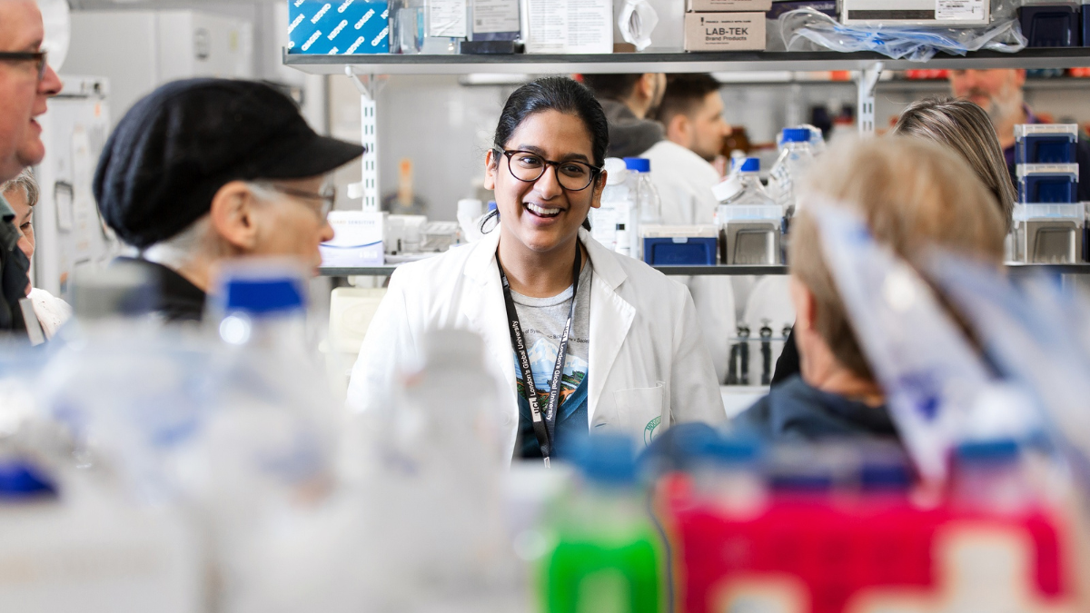 A medical researcher shown in the lab with a Moorfields lab coat on.