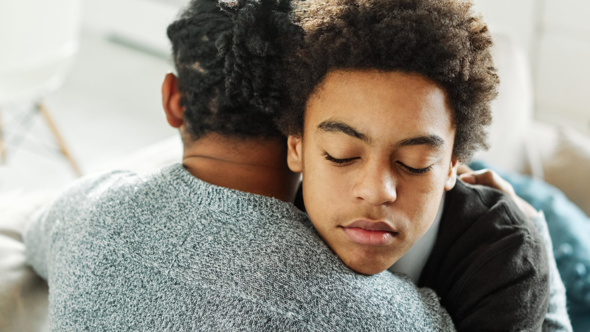 Stock image of two young men hugging
